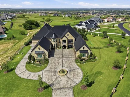 an aerial view of a house with a swimming pool yard and outdoor seating