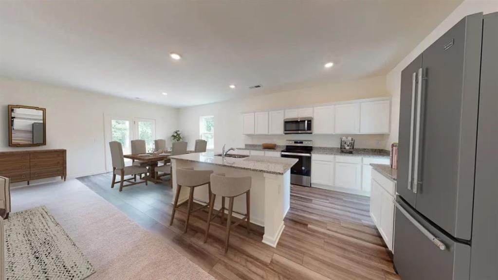 173 Hynes Street Winder, GA 30680 - Photo 6 of 20 a kitchen with a sink white cabinets and stainless steel appliances