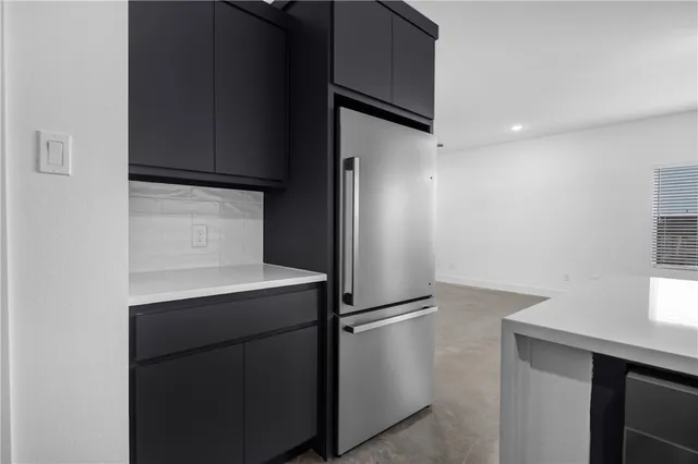a kitchen with a refrigerator and a sink