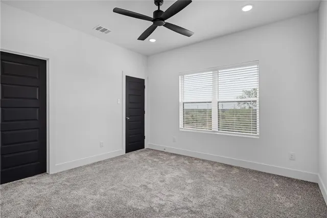 a view of a livingroom with a ceiling fan and window