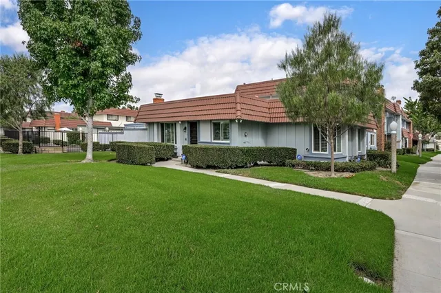 a front view of house with yard and green space