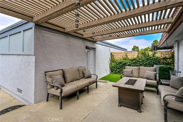 a patio with patio couch and a swing