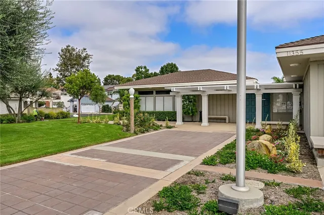 a front view of a house with a garden and plants