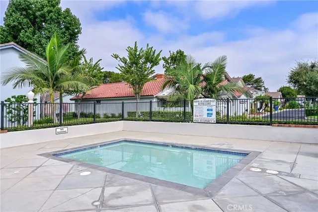 a view of a white house with a large pool and a yard