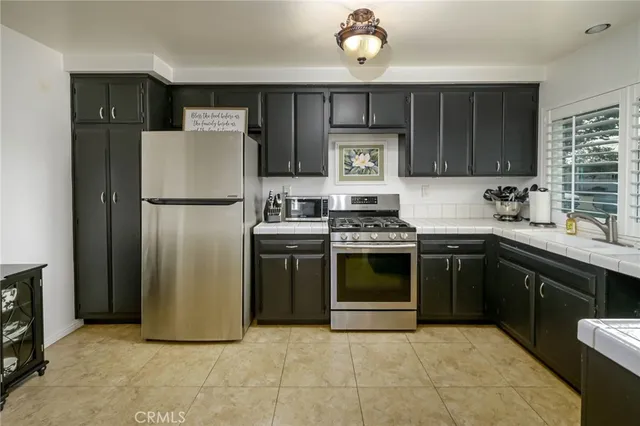 a kitchen with a refrigerator sink and stove