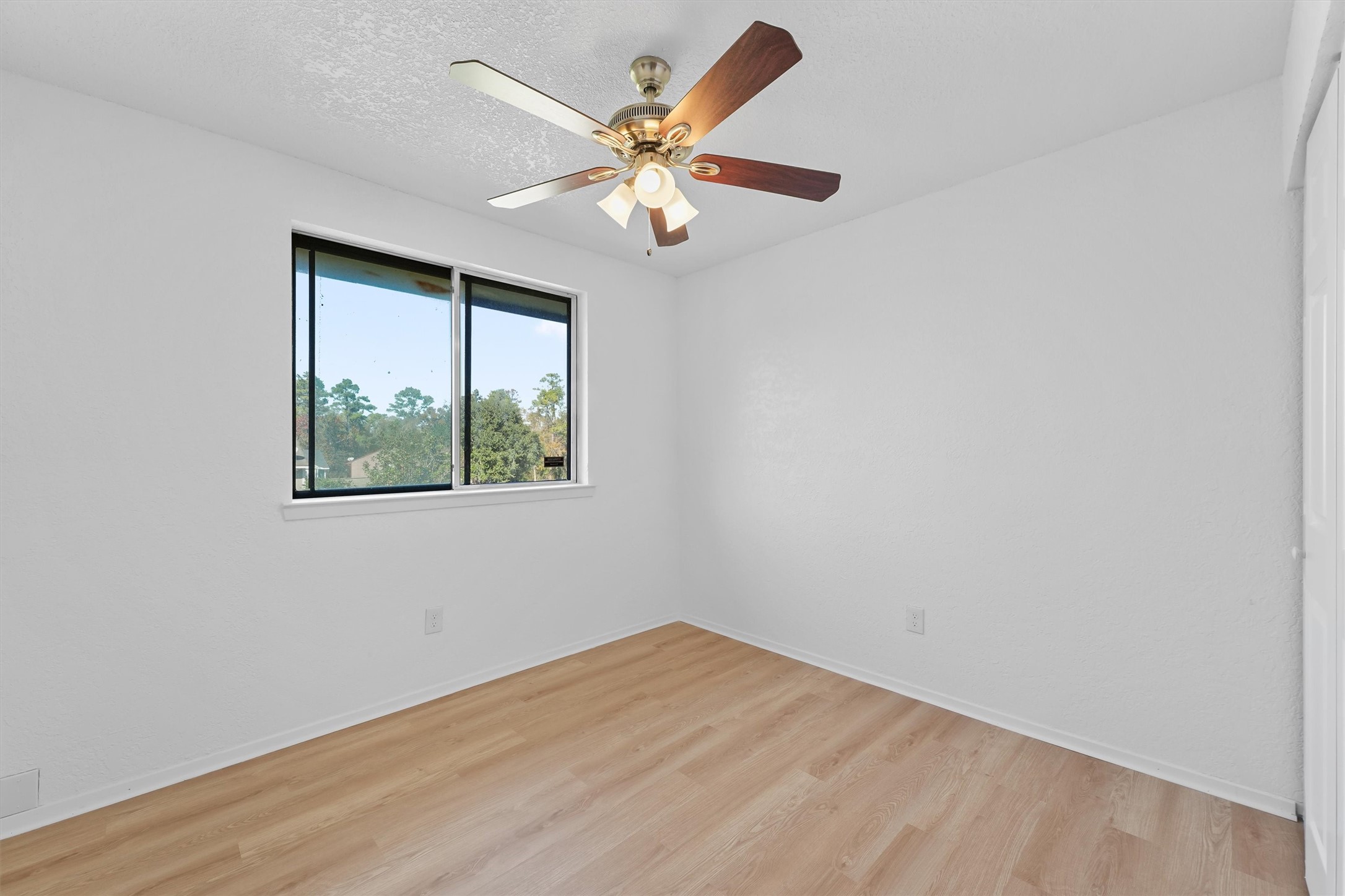3223 Deer Valley Drive Spring, TX 77373 - Photo 17 of 25 an empty room with a window and a ceiling fan
