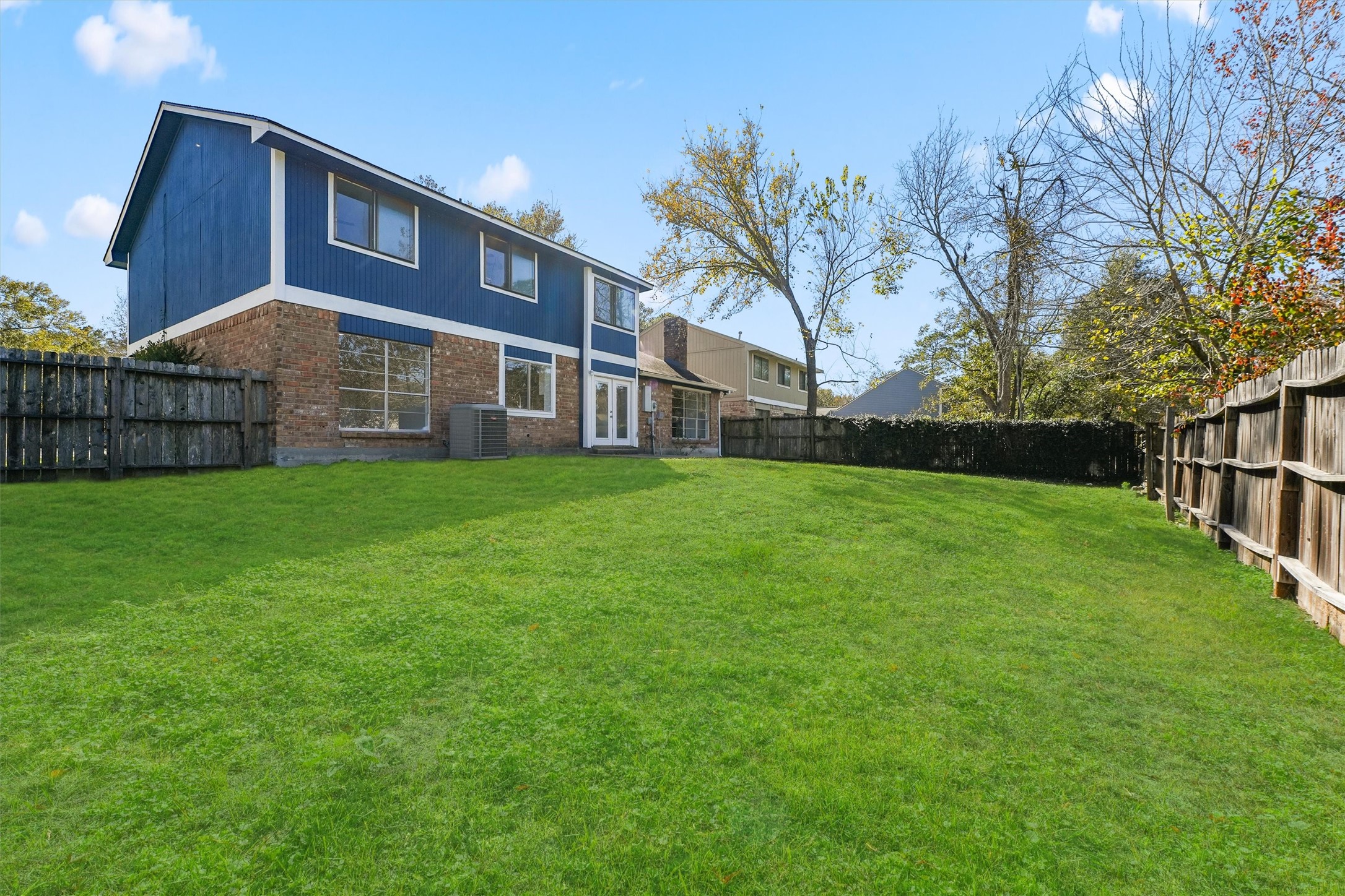 3223 Deer Valley Drive Spring, TX 77373 - Photo 24 of 25 a view of a yard in front of a brick house with large trees