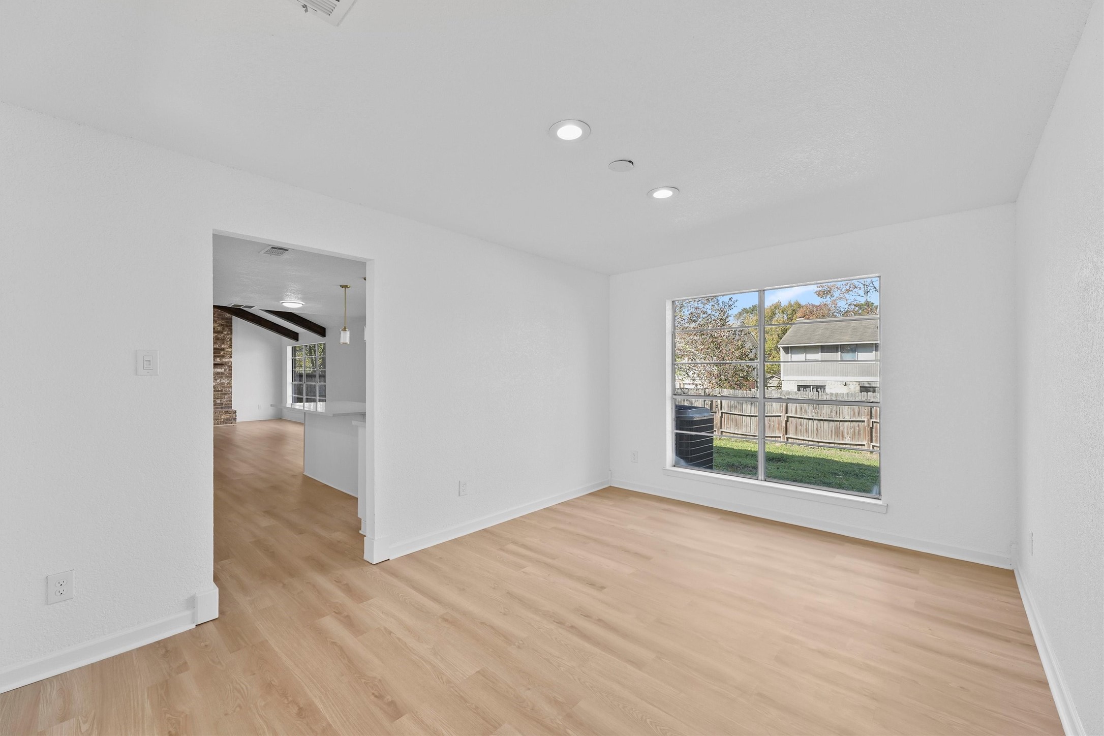 3223 Deer Valley Drive Spring, TX 77373 - Photo 7 of 25 a view of an empty room with wooden floor and a window