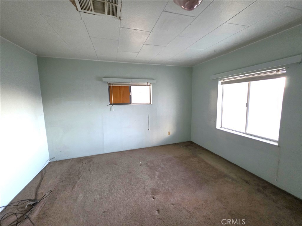 14055 Palm Street Cabazon, CA 92230 - Photo 12 of 22 an empty room with windows