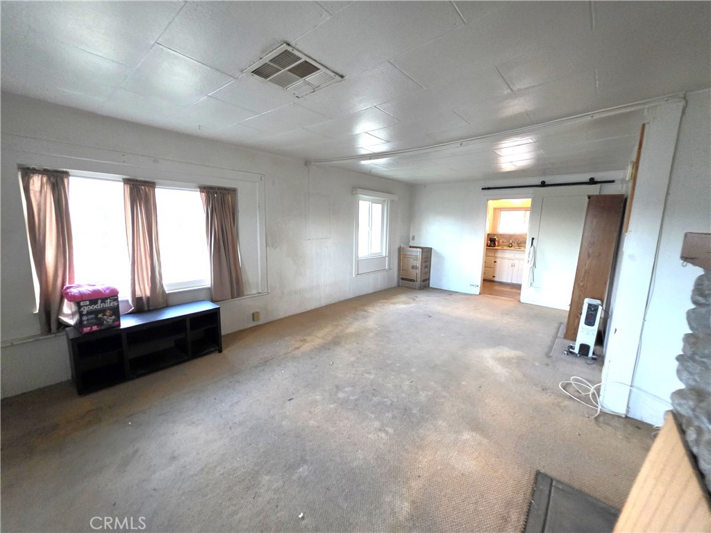 14055 Palm Street Cabazon, CA 92230 - Photo 13 of 22 a living room with furniture and a large window