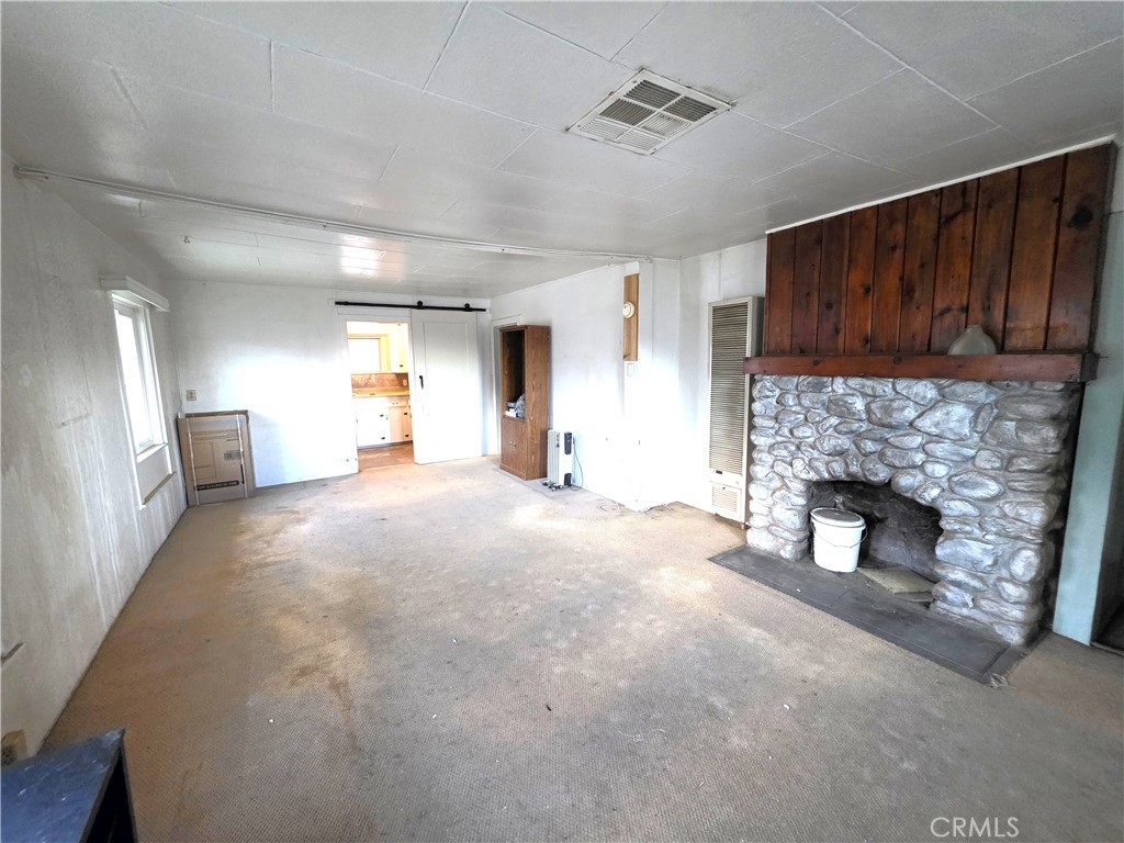 14055 Palm Street Cabazon, CA 92230 - Photo 14 of 22 a view of empty room with a fireplace