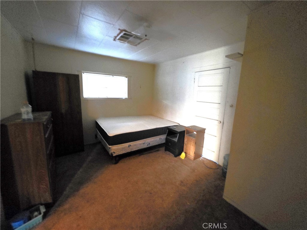 14055 Palm Street Cabazon, CA 92230 - Photo 17 of 22 a bedroom with a bed and a window