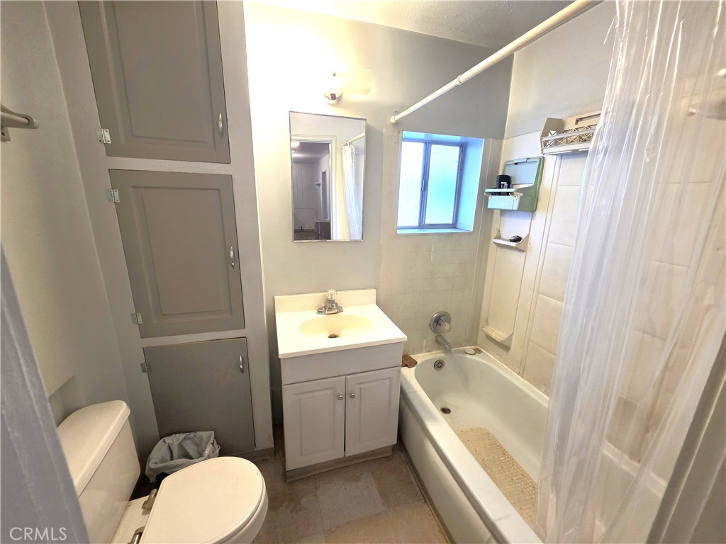 14055 Palm Street Cabazon, CA 92230 - Photo 19 of 22 a bathroom with a sink a toilet and shower