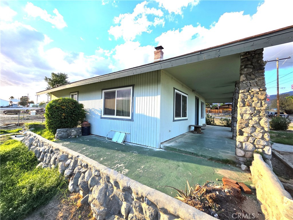 14055 Palm Street Cabazon, CA 92230 - Photo 2 of 22 a front view of a house with garden