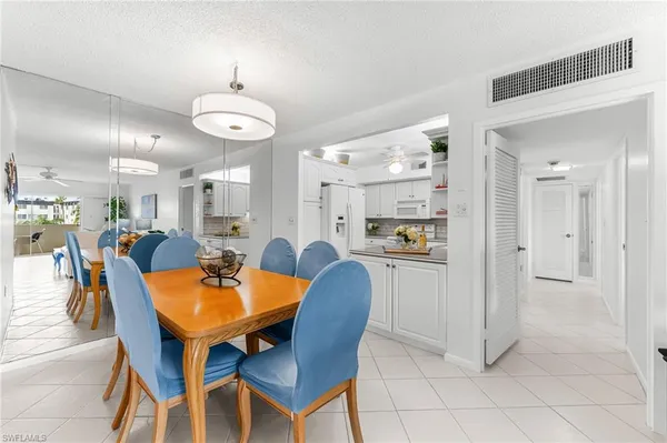 a kitchen with refrigerator and cabinets
