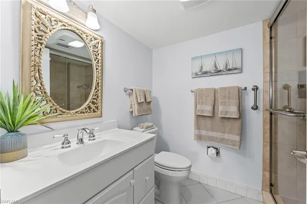 a bed room with bed and mirror