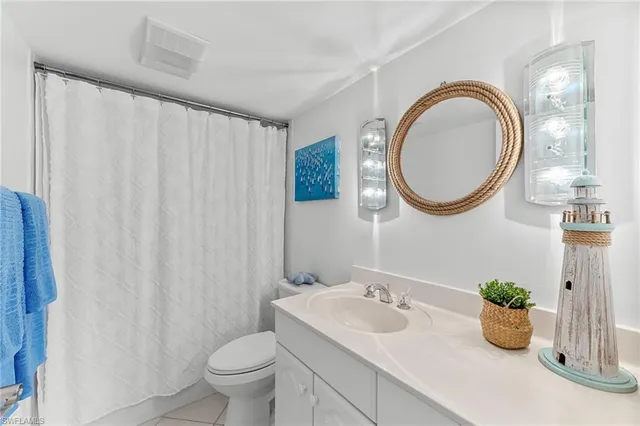 a view of a dining room with furniture a chandelier and wooden floor