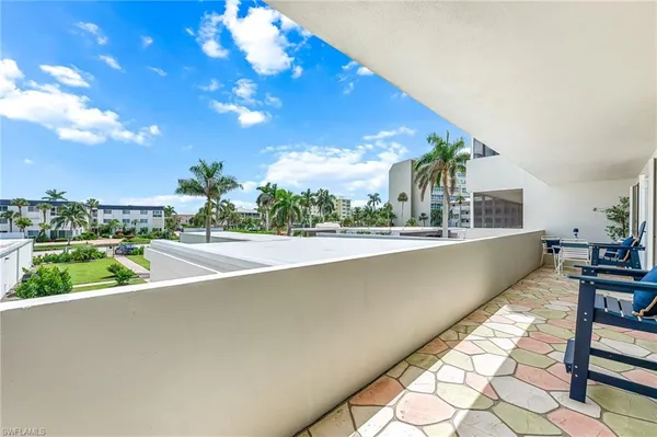 a dining room with furniture window and wooden floor