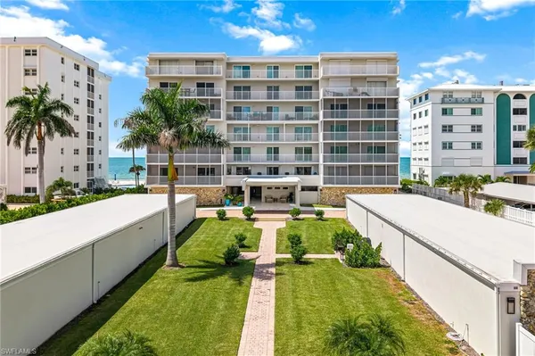 a view of a swimming pool with a patio and a yard