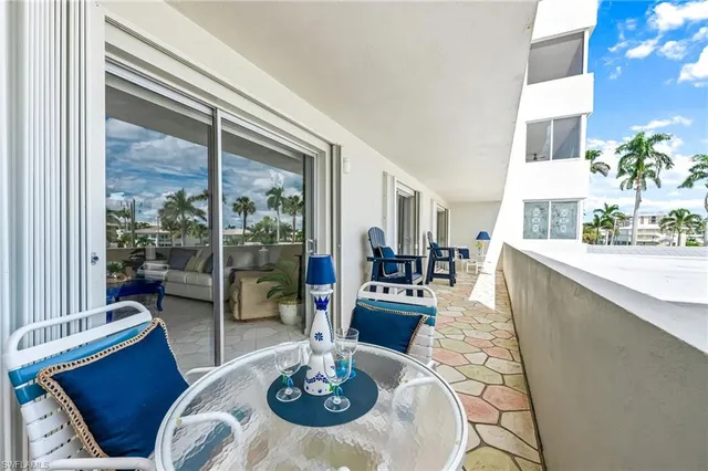 a dining room with furniture a chandelier and wooden floor