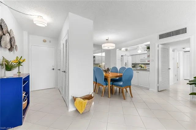 a view of a dining room with furniture and a chandelier