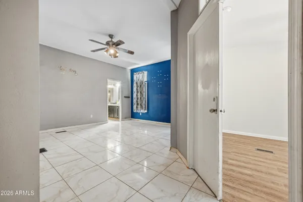 a view of an empty room with a ceiling fan