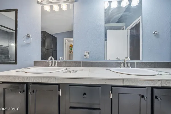 a bathroom with a granite countertop sink a large mirror and