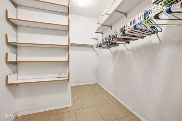 a view of walk in closet with empty racks