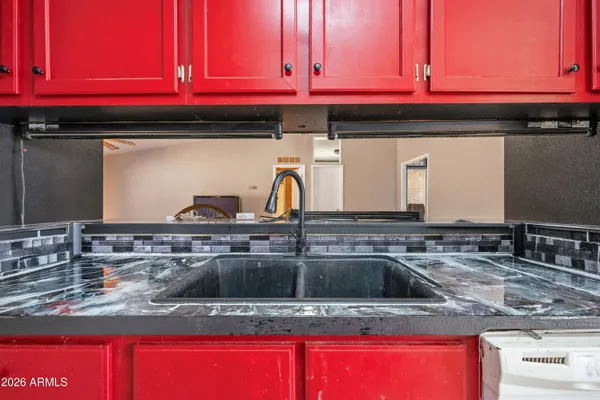 a kitchen with stove top oven a sink and dishwasher