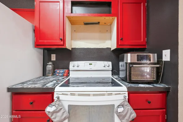 a stove top oven sitting inside of a kitchen