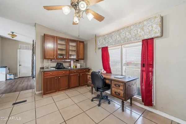 a view of a workspace with furniture and a window