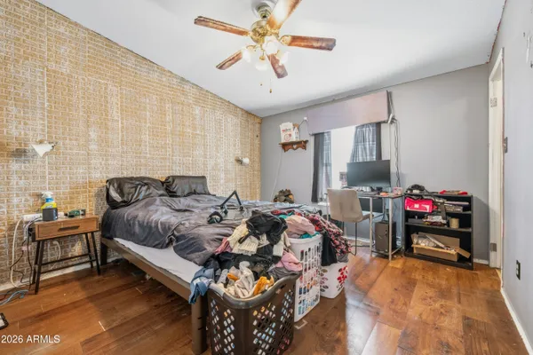 a bedroom with bed and a chandelier