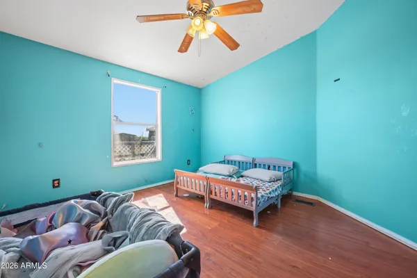 a bedroom with a bed and a chandelier