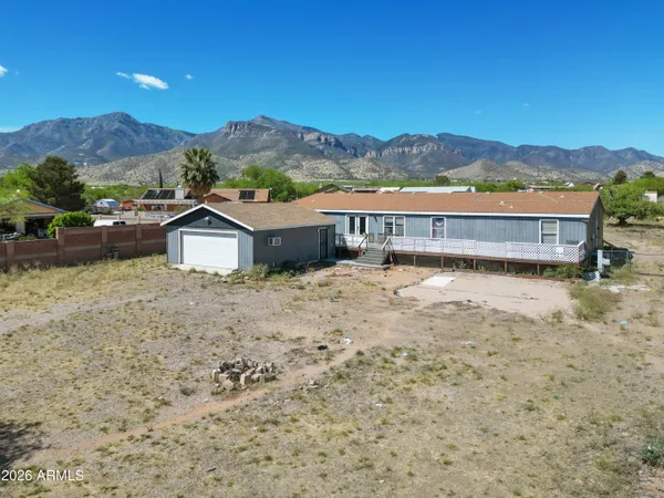 a view of a house with a yard and a mountain view