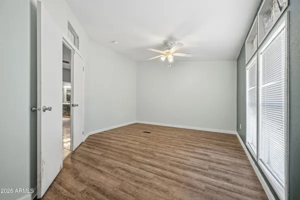 wooden floor in an empty room with a window
