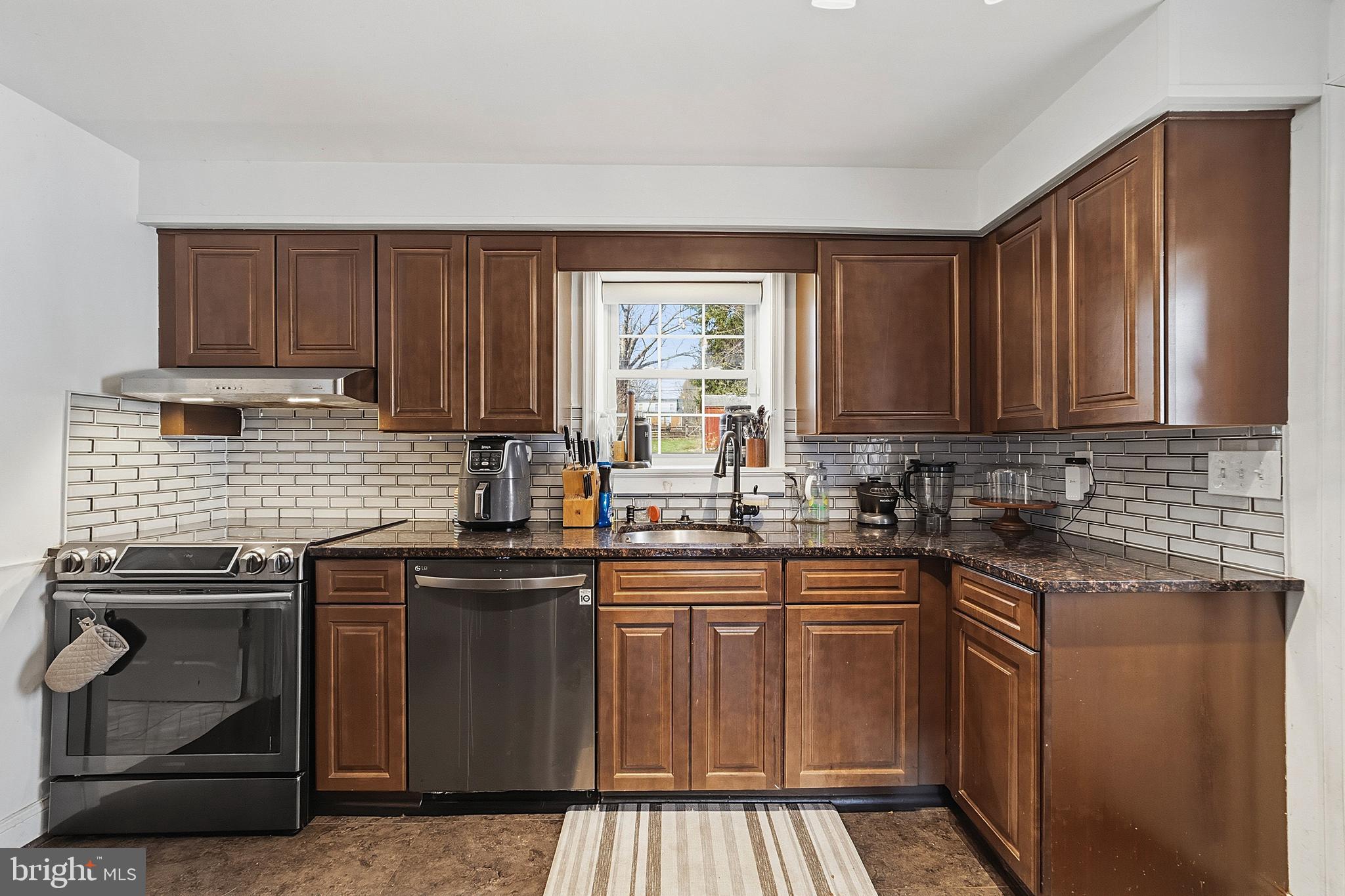 310 Greenwood Road Lansdale, PA 19446 - Photo 9 of 24 a kitchen with stainless steel appliances granite countertop a stove sink and cabinets
