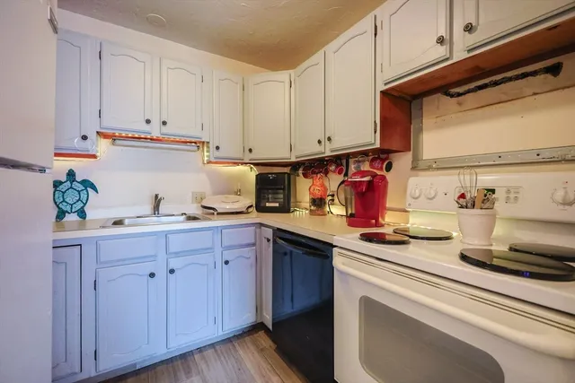 a kitchen with cabinets a sink and appliances