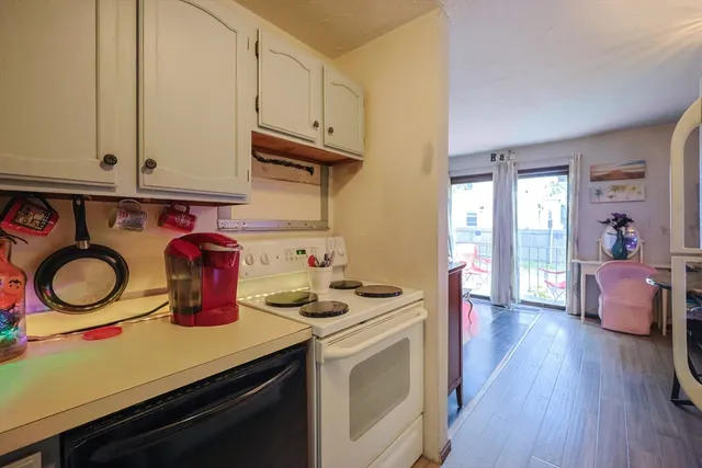 a kitchen with stove and cabinets