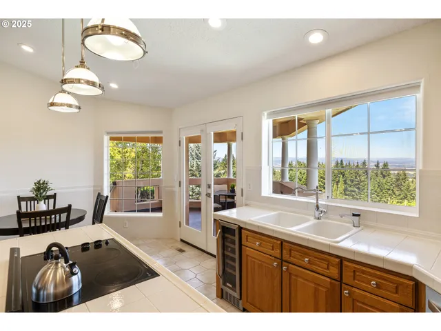 a spacious bathroom with a granite countertop sink a large mirror and a large window
