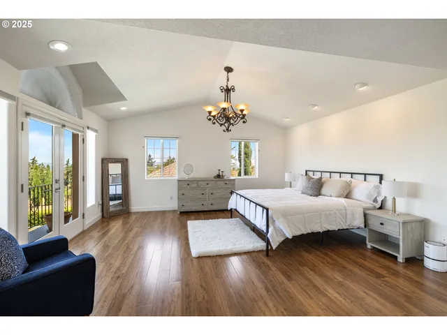 a spacious bedroom with a bed and a couch