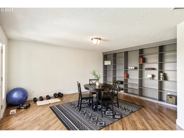 a living room with furniture a rug and white walls