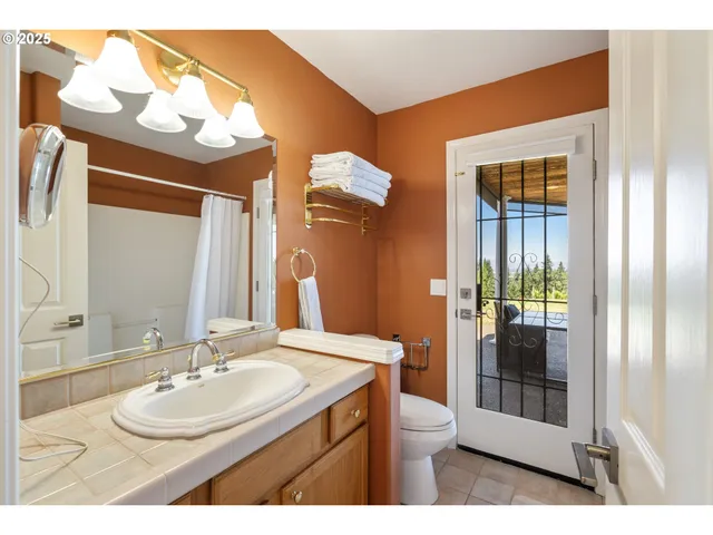 a bathroom with a sink a mirror and a shower