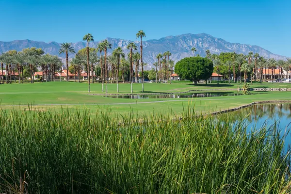 a view of a golf course with a lake view