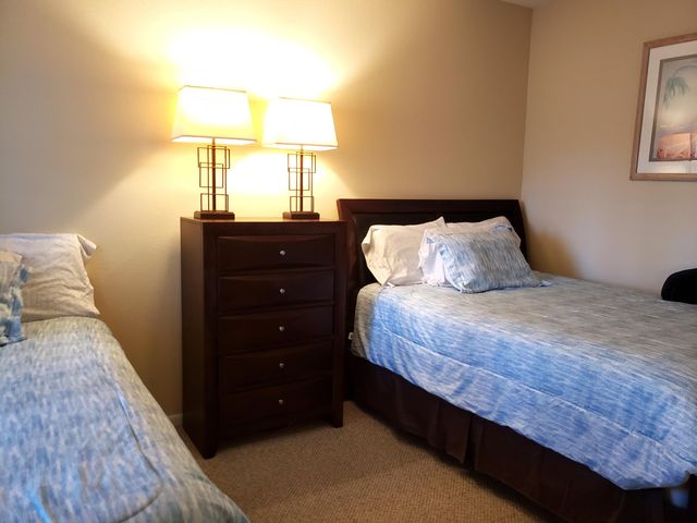 a bedroom with a bed and a lamp