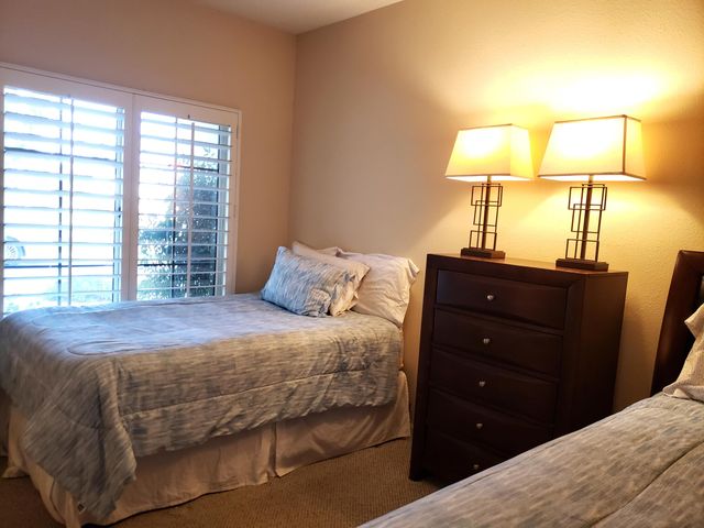 a bedroom with a bed and a lamp