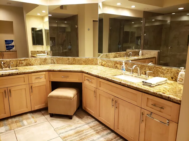 a spacious bathroom with a granite countertop sink and a mirror