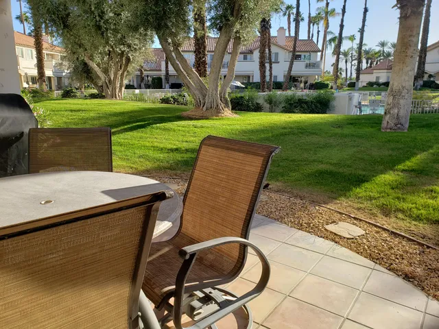 a view of a backyard with sitting area