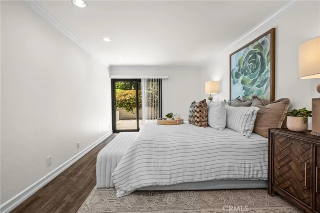 a bedroom with a bed and a potted plant