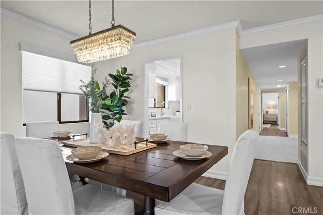 a view of a dining room with furniture and a chandelier