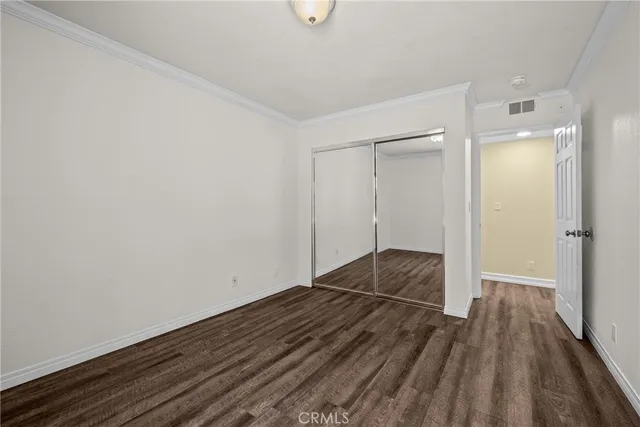 a hallway with dining area and wooden floor